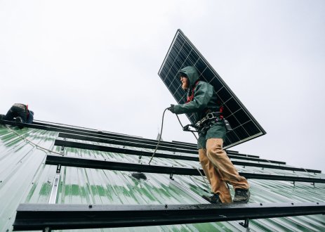 Technicians installing solar panels.