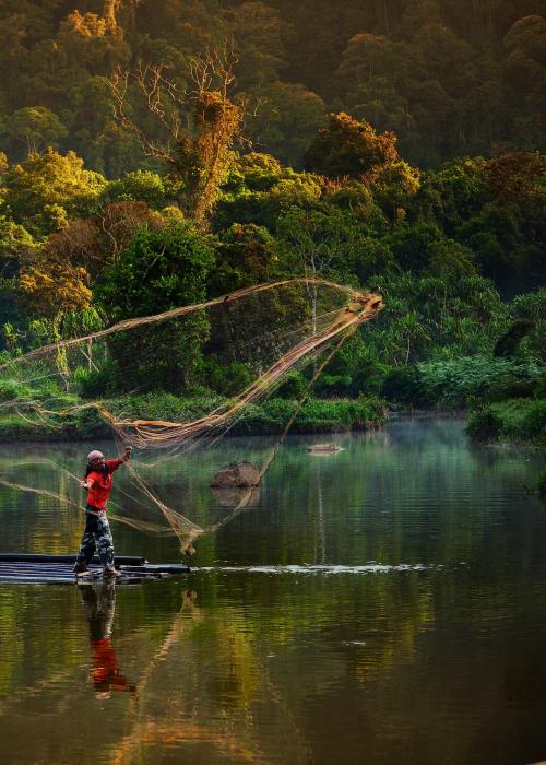 Man using traditional fishing net.