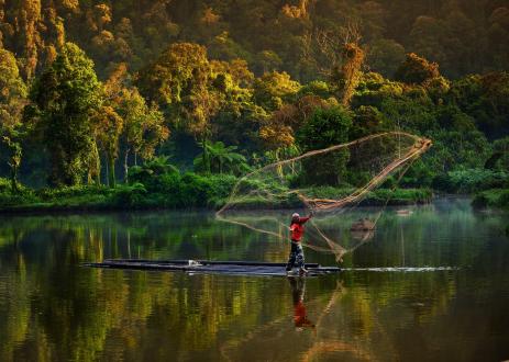 Man using traditional fishing net.