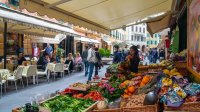 People walk through an Italian food market.
