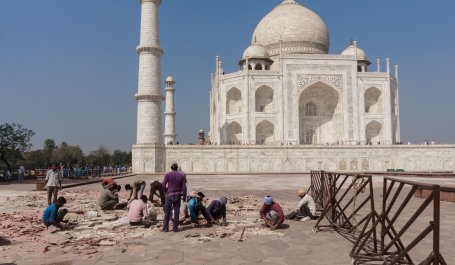 Workers repair the grounds outside the Taj Mahal in India.