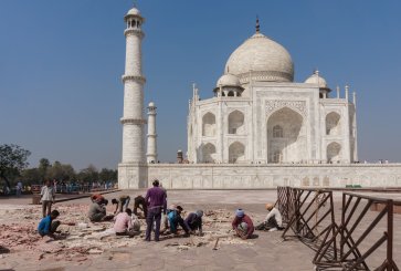 Workers repair the grounds outside the Taj Mahal in India.