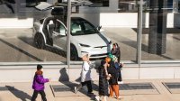 People walk by a Tesla showroom in New York City.