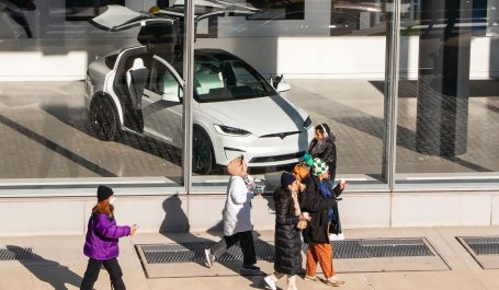 People walk by a Tesla showroom in New York City.
