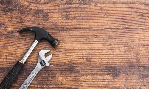 Hammer and wrench on wood
