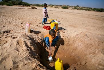A young girl collects water in the Banderbayla district within Somalia's Karkar region