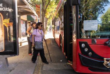 Passengers boarding bus in Mexico.