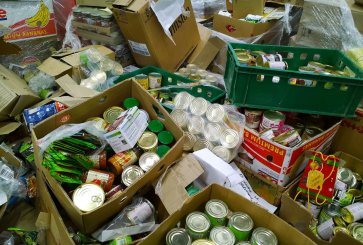 Boxes of canned goods and other products discarded at a supermarket.