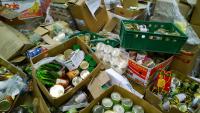 Boxes of canned goods and other products discarded at a supermarket.