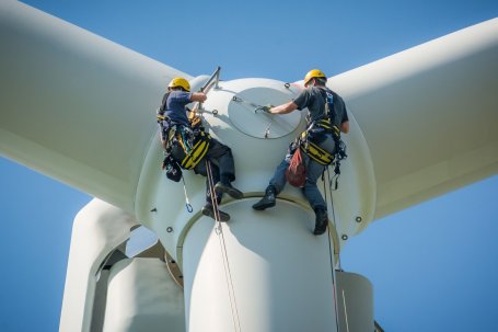 Maintenance workers service a giant wind turbine