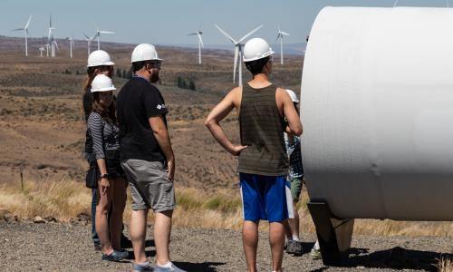 Visitors inspect a wind turbine blade