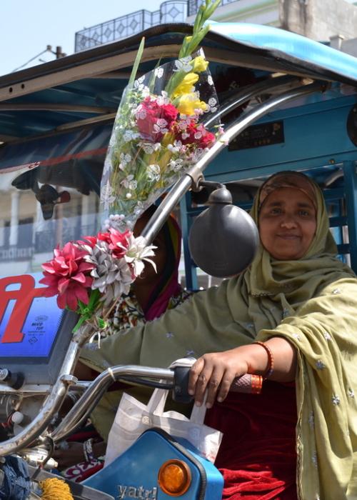 Woman in vehicle with flowers