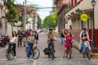 A group of cyclists celebrate people-centered streets in Manila