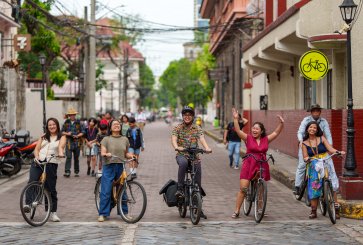 A group of cyclists celebrate people-centered streets in Manila