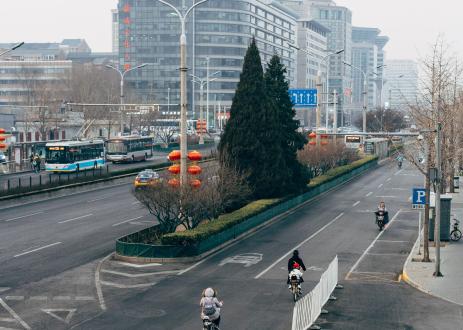 Roads with buses, cyclists and pedestrians in Beijing.