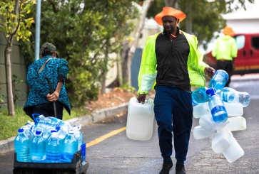 People collect water during the Cape Town water crisis.